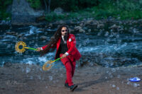 bubble wands in a red suit next to the river