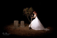 Bride with shovel over grave