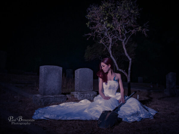 Bride with shovel over grave