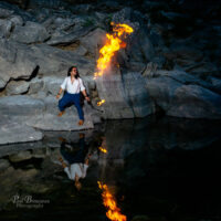 Fire breather reflecting in water