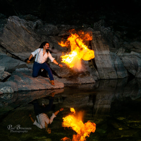 Fire breather reflecting in water